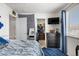 Bedroom featuring a walk-in closet, TV, closet, large window, and blue accents at 19707 E 59Th Pl, Aurora, CO 80019