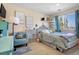 Sunny bedroom with chair and storage offers a peaceful retreat with neutral colors and a cozy atmosphere at 19707 E 59Th Pl, Aurora, CO 80019