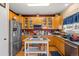 Well-equipped kitchen with stainless steel appliances, ample counter space, and wooden cabinetry at 19707 E 59Th Pl, Aurora, CO 80019