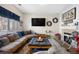 Cozy living room featuring a fireplace, plush seating, and stylish decor, creating a comfortable gathering space at 19707 E 59Th Pl, Aurora, CO 80019
