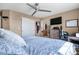 Main bedroom with ceiling fan features an ensuite bathroom, tv and large closet at 19707 E 59Th Pl, Aurora, CO 80019