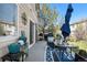 Cozy patio with elegant outdoor furniture, a grill, stylish planters, and a covered table with decor at 19707 E 59Th Pl, Aurora, CO 80019