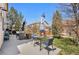 Spacious patio featuring outdoor seating, a large grill, and an umbrella, perfect for backyard entertaining at 19707 E 59Th Pl, Aurora, CO 80019