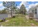 Backyard featuring a detached garage and mature trees perfect for relaxing outside at 762 S Paddock St, Elizabeth, CO 80107