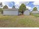 View of the detached one-car garage and storage shed in the back yard with a chain link fence at 762 S Paddock St, Elizabeth, CO 80107
