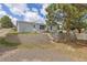 Charming backyard featuring a sturdy retaining wall, a well-maintained lawn and mature trees at 762 S Paddock St, Elizabeth, CO 80107
