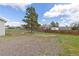 Fenced backyard with mature trees and some vegetation at 762 S Paddock St, Elizabeth, CO 80107