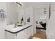 Bright bathroom featuring a double vanity sink, white cabinets, and stylish fixtures at 762 S Paddock St, Elizabeth, CO 80107