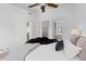 Bedroom featuring neutral decor, ceiling fan and multiple closets at 762 S Paddock St, Elizabeth, CO 80107