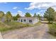 Charming single-story home featuring a gravel drive and well-maintained landscaping at 762 S Paddock St, Elizabeth, CO 80107