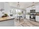 Eat-in kitchen features modern appliances, white cabinetry and natural light at 762 S Paddock St, Elizabeth, CO 80107