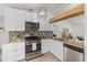 Modern kitchen with stainless steel appliances and bright lighting at 762 S Paddock St, Elizabeth, CO 80107