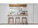 Eat-in kitchen featuring a breakfast bar with pendant lighting and wood countertops at 762 S Paddock St, Elizabeth, CO 80107