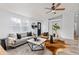 Bright living room with lots of natural light, ceiling fan and hardwood floors at 762 S Paddock St, Elizabeth, CO 80107