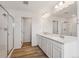 Well-lit bathroom with dual vanity, a glass shower, and modern fixtures for a luxurious experience at 190 Lark Sparrow Way, Bennett, CO 80102