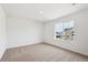 Empty room with carpet and a window, allowing for customization in a bright and airy space at 190 Lark Sparrow Way, Bennett, CO 80102