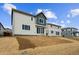 Modern home with a light gray exterior, dark trim, large sliding glass doors, and newly landscaped yard at 190 Lark Sparrow Way, Bennett, CO 80102
