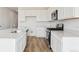 Modern kitchen featuring white cabinets, stainless steel appliances, sleek countertops, and a functional center island at 190 Lark Sparrow Way, Bennett, CO 80102