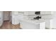 Modern kitchen featuring white cabinets, stainless steel appliances, sleek countertops, and a functional center island at 190 Lark Sparrow Way, Bennett, CO 80102
