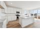 Modern kitchen featuring white cabinets, stainless steel appliances, sleek countertops, and a functional center island at 190 Lark Sparrow Way, Bennett, CO 80102