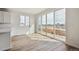 Bright living room featuring wood floors, neutral paint, and large sliding glass doors leading to the yard at 190 Lark Sparrow Way, Bennett, CO 80102