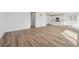 Open-concept living area showcasing light wood floors and seamless flow to the kitchen, ideal for modern living at 190 Lark Sparrow Way, Bennett, CO 80102