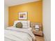 Cozy bedroom with mustard yellow accent wall, a stylish bedside table and a neutral color palette at 2255 18Th St, Boulder, CO 80302