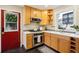 A modern kitchen boasts wooden cabinetry, granite countertops, and stainless steel appliances at 2255 18Th St, Boulder, CO 80302