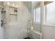 Elegant shower featuring white tile, glass enclosure, a convenient bench, and sleek hardware at 2255 18Th St, Boulder, CO 80302