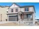 Two-story house with gray siding, red shutters, and a gray three-car garage at 18344 Prince Hill Cir, Parker, CO 80134