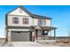 Two-story house with gray siding, red shutters, and a gray three-car garage at 18344 Prince Hill Cir, Parker, CO 80134