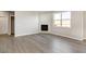 Living room with hardwood floors and corner fireplace at 18344 Prince Hill Cir, Parker, CO 80134