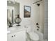 Bright bathroom with white vanity, modern fixtures, and a shower-tub combination at 6153 N Ceylon St # 104, Denver, CO 80249