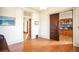 Sunlit room featuring hardwood floors with views into adjacent room with sliding door and built-in bookshelf at 2914 W 29Th Ave, Denver, CO 80211