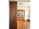 Interior view of a room with a large bookshelf, hardwood floors, and period sliding door at 2914 W 29Th Ave, Denver, CO 80211