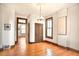 Spacious living room with hardwood floors, vintage light fixture, and doorways to other rooms at 2914 W 29Th Ave, Denver, CO 80211