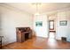 Bright living room featuring gleaming hardwood floors and an antique secretary desk, framed by white walls at 2914 W 29Th Ave, Denver, CO 80211