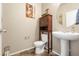 Cozy half bath featuring a pedestal sink, stylish fixtures, and decor at 13673 Valentia St, Thornton, CO 80602