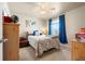 Well-lit bedroom featuring a ceiling fan, carpeted floors and exterior view at 13673 Valentia St, Thornton, CO 80602