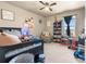 Bedroom featuring a ceiling fan, carpeted floors, and natural light at 13673 Valentia St, Thornton, CO 80602