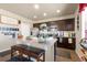 Bright kitchen featuring modern cabinets, a central island with seating, and decorative accents throughout at 13673 Valentia St, Thornton, CO 80602