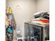 Functional laundry room featuring storage shelves and modern washer/dryer at 13673 Valentia St, Thornton, CO 80602