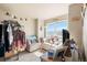 Bright living room with neutral tones, a cozy armchair, and large window with natural light at 13673 Valentia St, Thornton, CO 80602