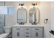 Stylish bathroom with a double vanity, marble countertop, and modern lighting fixtures at 2233 Kipling St, Lakewood, CO 80215
