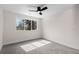 Neutral bedroom featuring a ceiling fan, carpet, and a large window for optimal sunlight at 2233 Kipling St, Lakewood, CO 80215