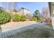 Spacious backyard deck surrounded by mature landscaping and brick retaining wall at 10273 Nottingham Dr, Parker, CO 80134