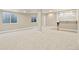 Open basement space with a large carpeted area and a built-in bar at 10273 Nottingham Dr, Parker, CO 80134