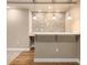 Basement bar area with stone accent wall and pendant lights at 10273 Nottingham Dr, Parker, CO 80134