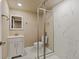 Modern bathroom with walk-in glass shower, marble tile and vanity with storage at 10273 Nottingham Dr, Parker, CO 80134