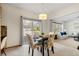 Inviting dining area featuring modern lighting, a dining table for four, and easy access to the backyard at 10273 Nottingham Dr, Parker, CO 80134